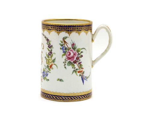 A Worcester porcelain mug, c.1770-1780, of cylindrical form, the body decorated with floral sprays within blue and gilt-decor