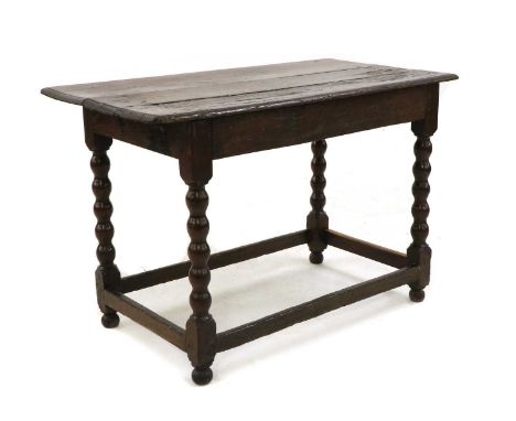 A 17th century oak side table, the rectangular top above frieze drawers on bobbin supports, 105cm wide, 57cm deep, 71cm highC