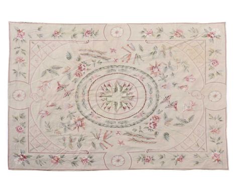 An Aubusson style needlepoint carpet, decorated with a central medallion enclosed by foliate motifs, 300 x 240cmCondition rep