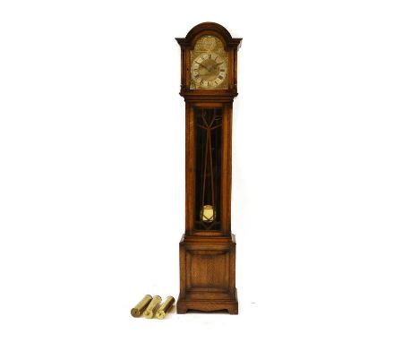 A 1930's/40's oak cased longcase clock, with arched brass dial, striking and chiming on four and eight bar gongs and with pul