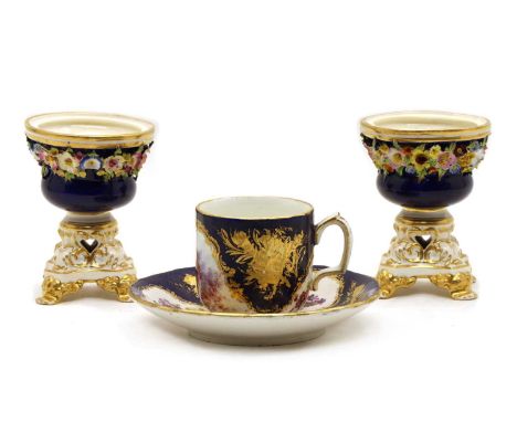 A Sèvres style cup and saucer, c.1850, painted with panels of lovers and flowers on a cobalt blue gilt ground; a pair of Derb