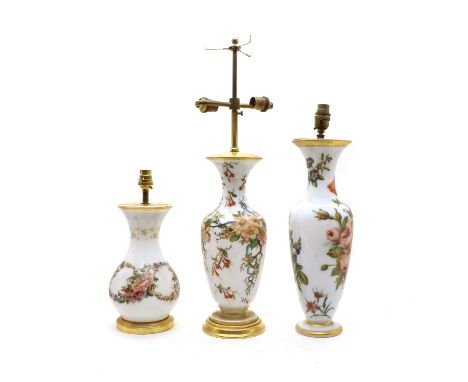 A group of three Opaline and enamelled table lamps, late 19th Century, French, in the manner of Baccarat, each decorated with