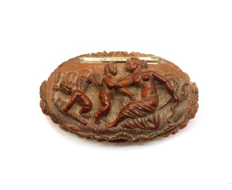 A coquilla nut snuff box, 19th century, of oval form the cover carved with Venus and two cupids, the base carved with scrolli