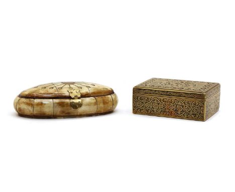 A carved horn box, of oval shape, with a brass hinge, the lid inlaid with brass in a radiating pattern, internally lined with