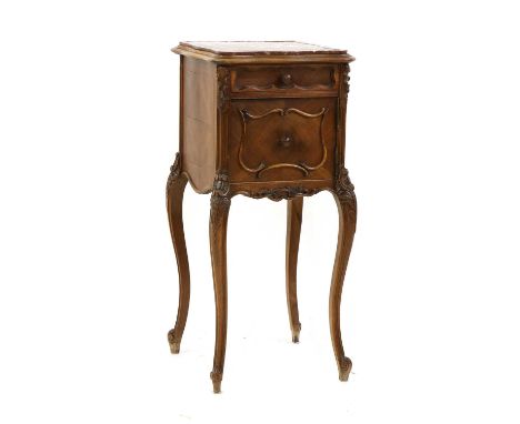 A French Louis XV-style walnut bedside cupboard, c.1900, the shaped square rouge marble top above a single drawer and a door,