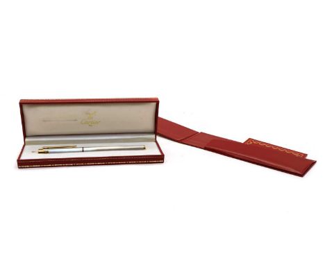 A Must de Cartier fountain pen, with a brushed white metal body, yellow metal fitments and screws to the lid, complete with f