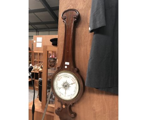 A WOODEN CASED BAROMETER WITH TURNED DESIGN 