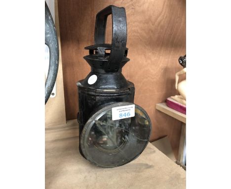 A VINTAGE RAILWAY LANTERN WITH BLACK AND WHITE LIGHT 