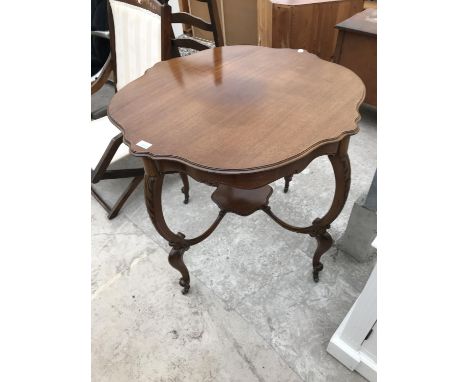 A MAHOGANY SIDE TABLE ON CARVED SUPPORTS WITH LOWER SHELF 