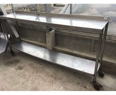 A STAINLESS STEEL TWO SHELF UNIT ON WHEELS 193CM X 41CM X 96CM HIGH 