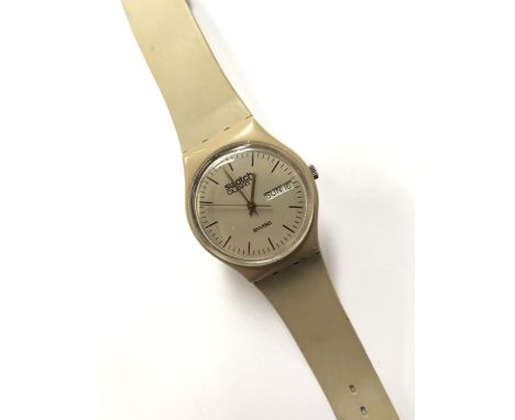 A GENTS SWATCH WATCH WITH DAY DATE FEATURE 