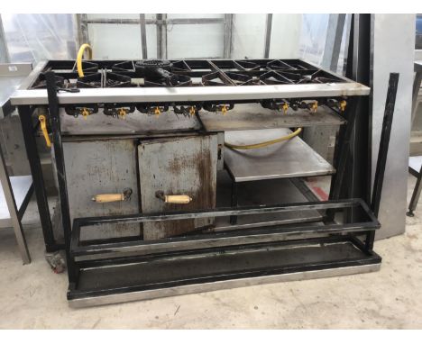 AN EIGHT RING GAS COOKER WITH SERVING SHELF 