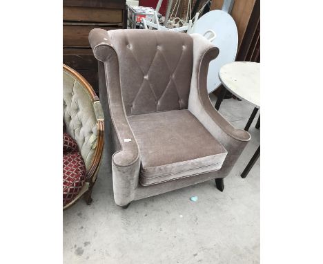 A BUTTON BACK FABRIC ARMCHAIR 