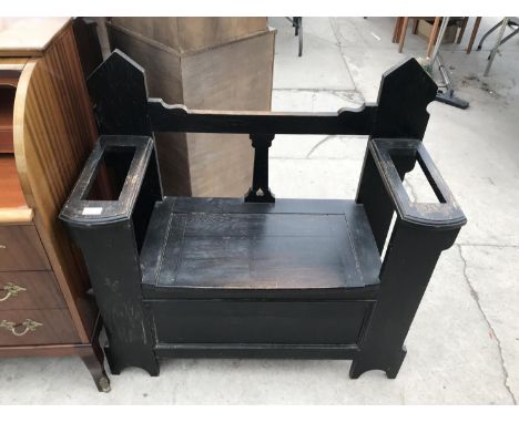 AN OAK HALL SEAT WITH HINGED SEAT AND STICK STAND COMPARTMENTS 