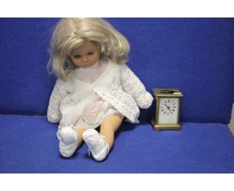 A CARRIAGE CLOCK AND A VINTAGE DOLL