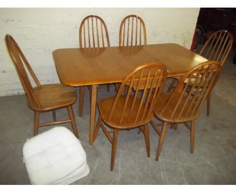 A LIGHT OAK DROPLEAF DINING SET WITH SIX CHAIRS IN THE STYLE OF ERCOL