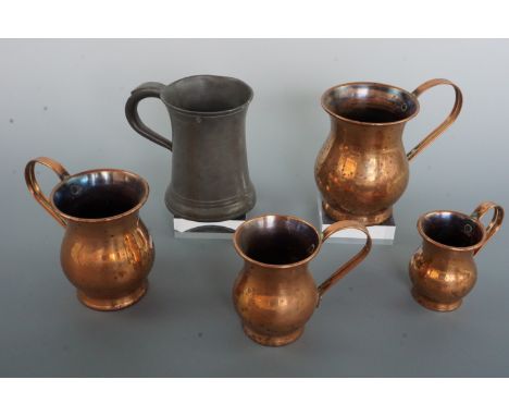 A Victorian pewter tankard by Yates &amp; Birch, together with a graded set of copper tankards / measures