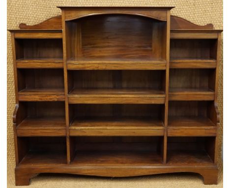 A George V mahogany break-front open book case, the shelf fronts having hinged aprons, 164 cm x 134 cm