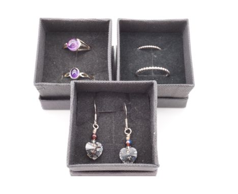 Contemporary white metal jewellery comprising a pair of beaded finger rings, two amethyst cabochon rings and a pair of facete