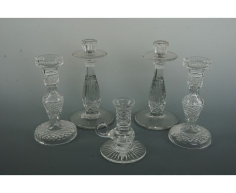 A fine pair of cut glass candlesticks, one other pair of glass candlesticks and a chamber stick, tallest 21 cm