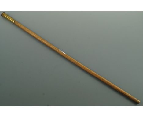 A swagger stick, the pommel fabricated from a brass shell case and mounted with a George VI button