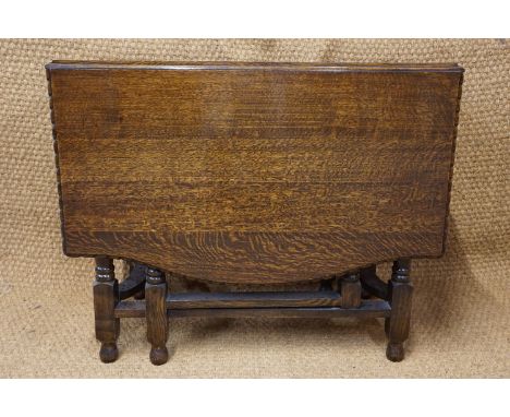 A George V oak gate-leg dining table, the rectangular top having a gadrooned edge, 90 cm 150 cm (open) a 75 cm high