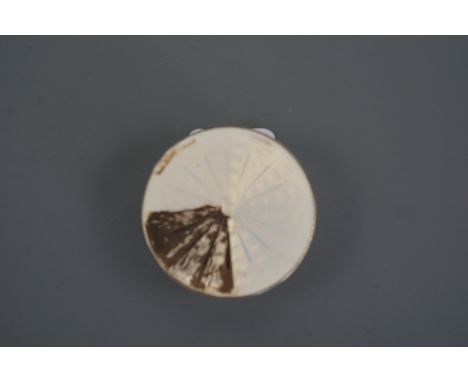 An Imperial Russian enamelled white metal pill box, of drum form, decorated with basse-taille enamelling over engine turning,