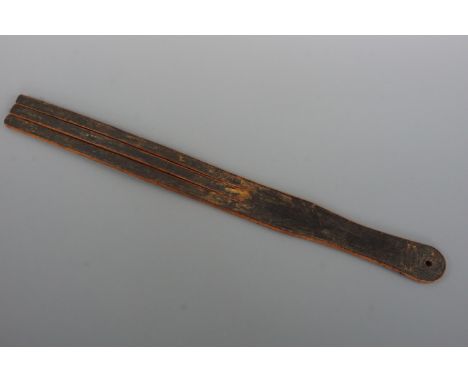 An early 20th Century Scottish school room corporal punishment leather tawse by McRostie &amp; Co of Glasgow, 56 cm