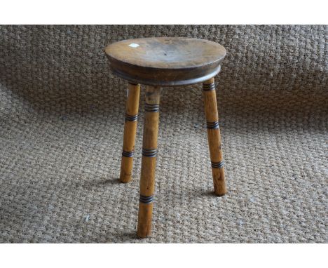 A small turned wooden three legged stool, 26 cm x 38 cm