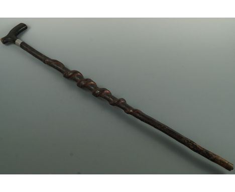 A late 19th / early 20th Century rustic walking stick, the shaft carved in the form of a serpent, 92 cm