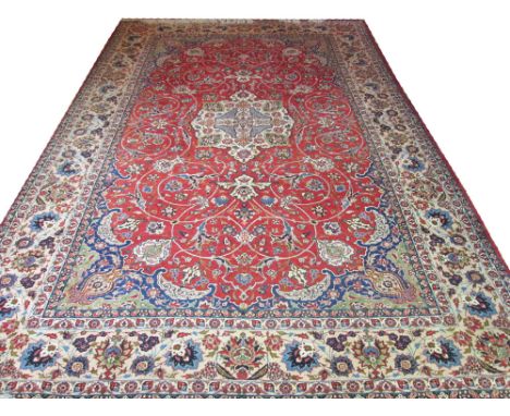 FINE PERSIAN ISPHAHAN CARPET, 520cm x 347cm, ivory organic medallion on a terracotta field of scrolling vines and palmettes w