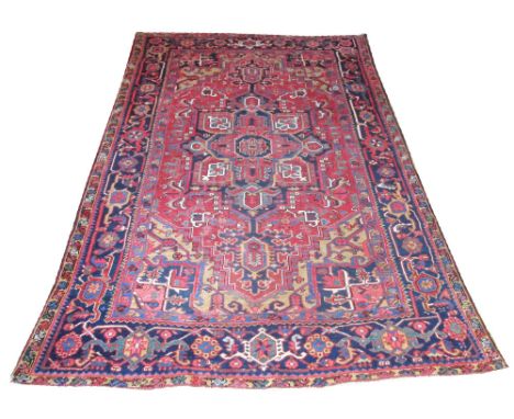 ANTIQUE HERIZ CARPET, 320cm x 220cm, traditional design of a central medallion on a terracotta field of stylised leaves and v