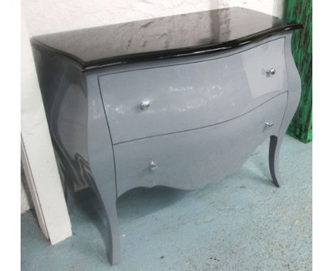BOMBE COMMODE, with an elephant grey finish and noir lacquered top containing two long drawers with silvered handles, 110cm l