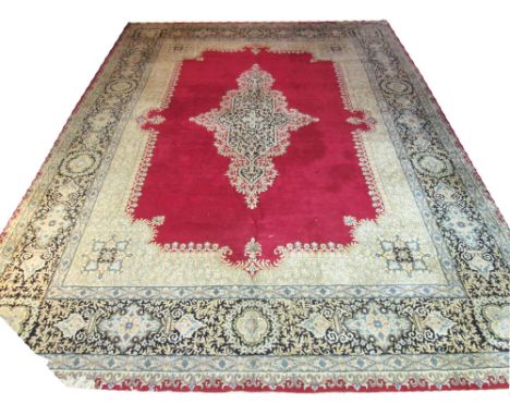 EZEPOS BENLIAN KERMAN CARPET, 525cm x 375cm, circa 1940, floral star medallion on a ruby field encompassed by matching spandr