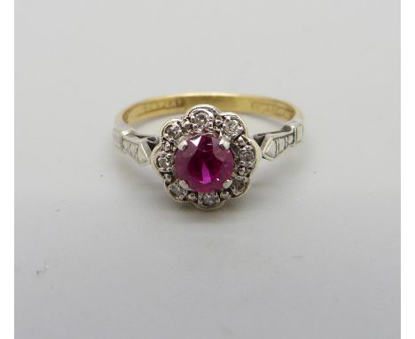 An 18ct gold, platinum set, ruby and diamond cluster ring, 2.4g, L 