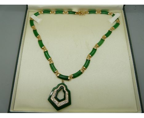A silver gilt and jade necklace 