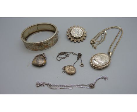A Victorian silver bangle, Birmingham 1880, a Victorian  brooch and three lockets, (inside of large locket a/f) 