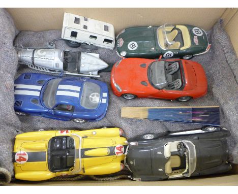 A box of assorted items, including metalwares and large scale Burago model vehicles 