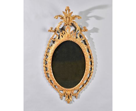 A George III gilt framed mirror with pierced acanthus crest, the oval plate with egg and dart border, 55cm wide x 103cm high.
