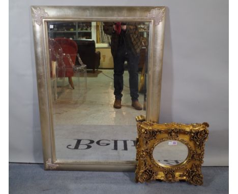 A Regency style gilt framed wall mirror with oval bevelled plate, 39cm wide x 36cm high and a 20th century silver painted rec
