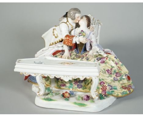 A Meissen group of lovers, late 19th century, modelled as a seated young woman playing the spinnet, her companion standing at