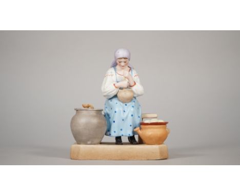 A Russian biscuit porcelain figure of a women on a bench, Gardner factory, late 19th century, red printed mark, 13cm high. 