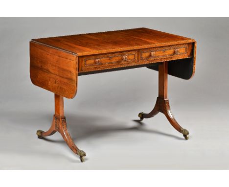 A Regency rosewood sofa table, with a pair of yew lined frieze drawers and dummy opposing, on four downswept supports, 100cm 