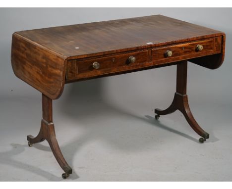 A George III mahogany sofa table, the pair of frieze drawers on slab trestle end standards with four downswept supports, 109c