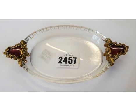 A gold, rose diamond set and red enamel mounted rock crystal oval twin handled trinket dish, the handles red enamelled to the