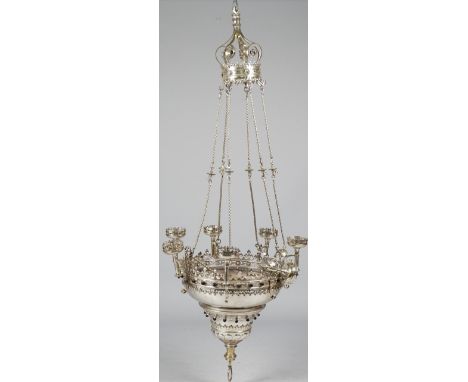 A silvered brass seven branch chandelier of Persian design, 20th century, with pierced and castellated rim, inset with ruby c