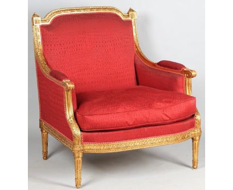 A large Louis XVI style gilt framed armchair with bow seat on tapering fluted supports, 87cm wide x 95cm high. 