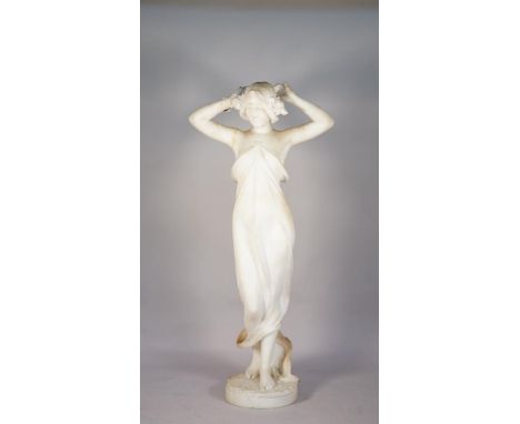 An Italian marble figure, late 19th century, Art Nouveau female standing, arms raised above her head, the plinth base, signed