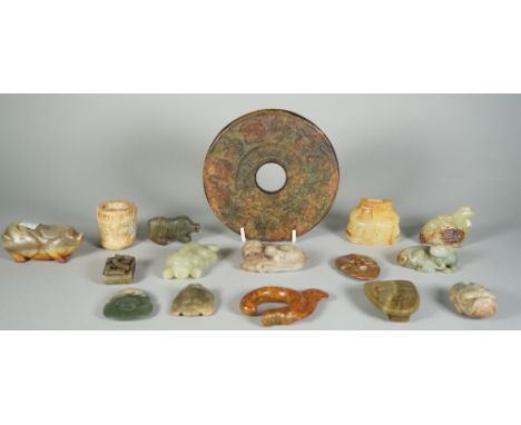 A group of Chinese archaistic jade carvings, of various colour and size, comprising; a large bi disc, 15cm. diameter; a sword