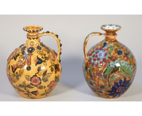 A Zsolnay Pecs ewer, early 20th century, decorated with flowers against a mottled buff ground, relief moulding to the handle 